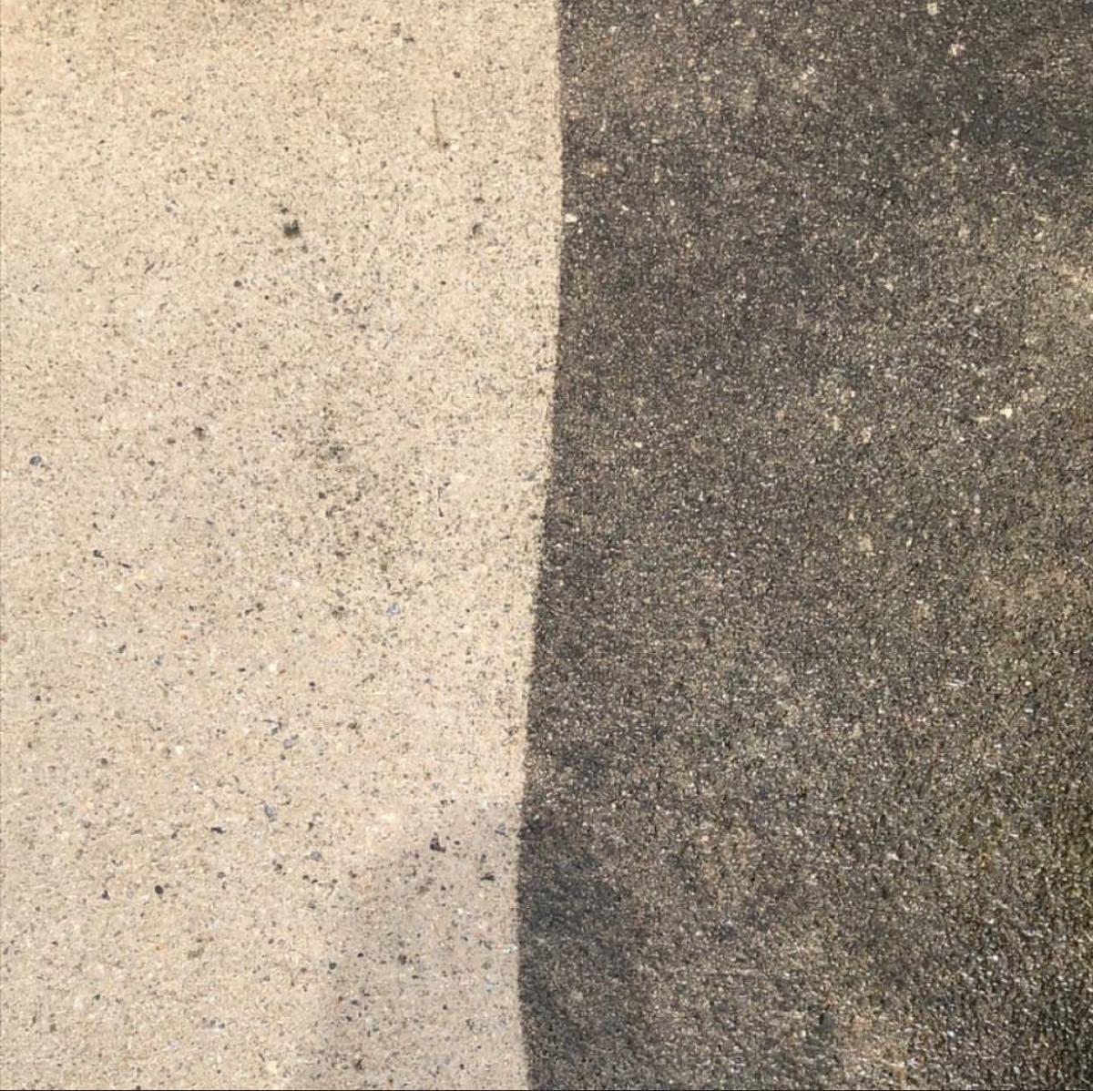 Close view of a cleaned section beside an uncleaned section of concrete, from EDM Services’ Nextdoor listing